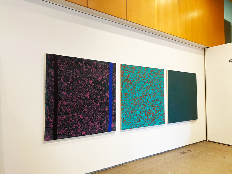 Three canvases, a triptych of related color stories. The left one uses a green background mixed with black, layered with magenta streaks all over the surface, and two vertical strips of color bracing the painting. The left vertical strip is purple, the right vertical strip is cobalt blue. The middle painting is a tinted green mixed with white, and red intertwined in brush strokes all over the surface. The painting on the right is the same green mixed with grey and has delineations of darker brushstrokes against the lighter wash of the background.
